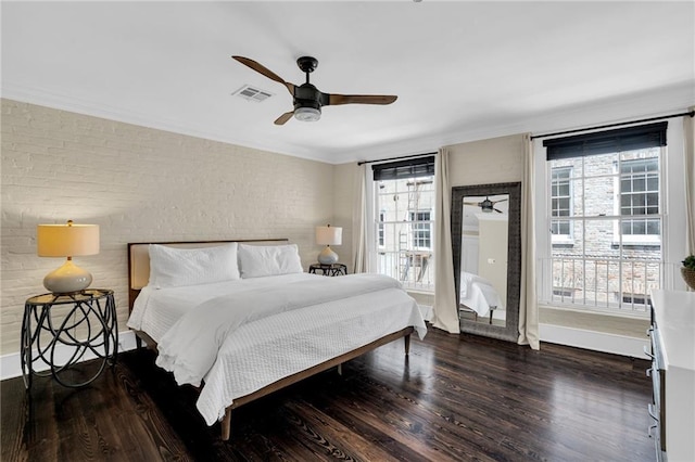 220 Decatur St Unit 304, New Orleans, LA 70130 - bedroom with multiple windows, wood finished floors, brick wall, ornamental molding, and ceiling fan