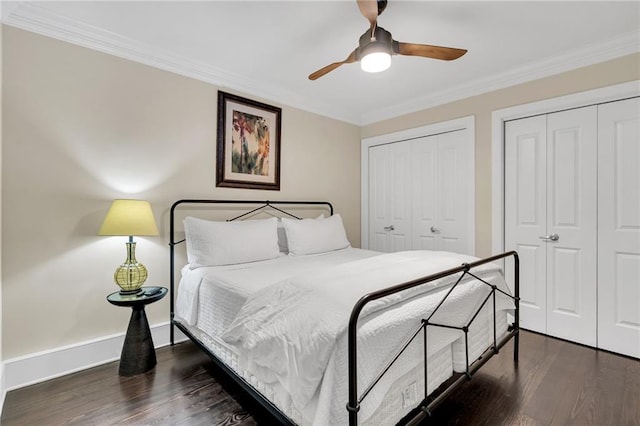 220 Decatur St Unit 304, New Orleans, LA 70130 - bedroom featuring two closets, dark wood-style flooring, ornamental molding, a ceiling fan, and baseboards