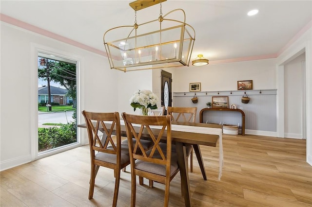 4721 Chastant St, Metairie, LA 70006 - dining area with light wood-type flooring, baseboards, and a chandelier