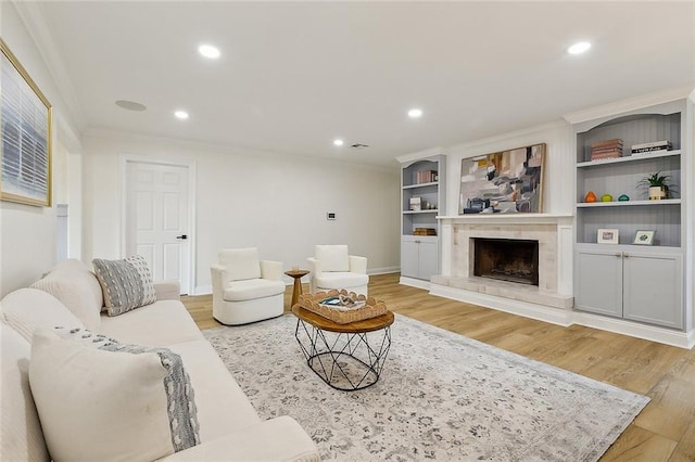 4721 Chastant St, Metairie, LA 70006 - living area with crown molding, light wood finished floors, recessed lighting, a fireplace with raised hearth, and baseboards