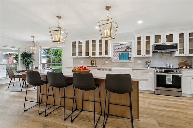 4721 Chastant St, Metairie, LA 70006 - kitchen featuring stainless steel appliances, a chandelier, white cabinets, decorative backsplash, and recessed lighting