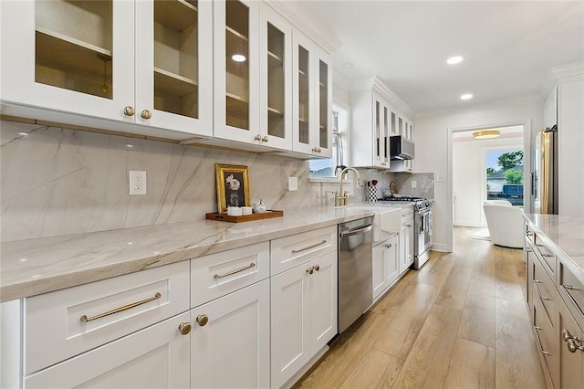 4721 Chastant St, Metairie, LA 70006 - kitchen with appliances with stainless steel finishes, a sink, healthy amount of natural light, decorative backsplash, and ornamental molding