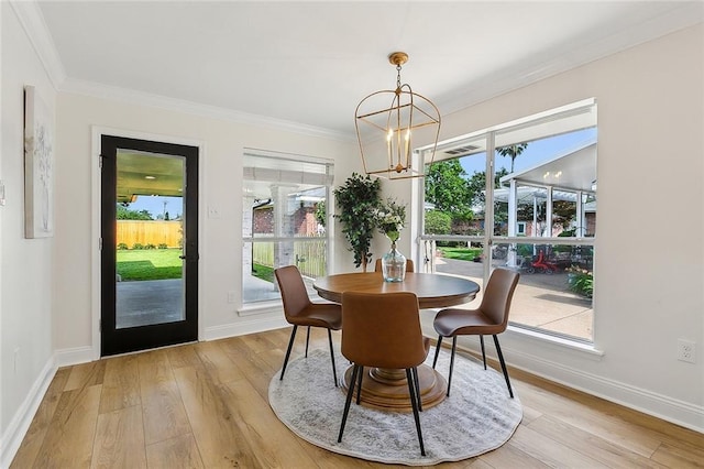 4721 Chastant St, Metairie, LA 70006 - dining room with a chandelier, light wood-type flooring, ornamental molding, baseboards, and healthy amount of natural light