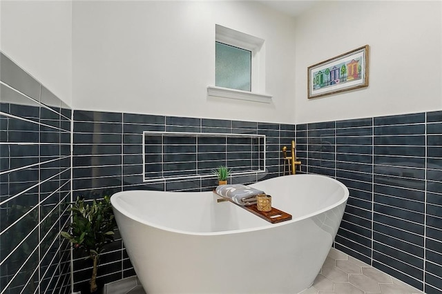4721 Chastant St, Metairie, LA 70006 - full bath featuring tile walls, tile patterned flooring, a soaking tub, and wainscoting