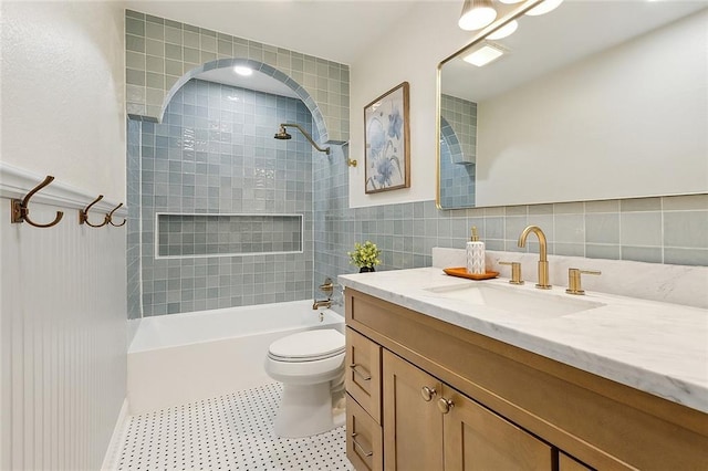 4721 Chastant St, Metairie, LA 70006 - full bathroom featuring vanity, toilet, shower / tub combination, tile walls, and wainscoting