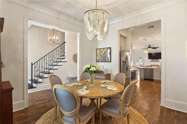 247 26th St, New Orleans, LA 70124 - dining area featuring a chandelier, stairway, dark wood finished floors, baseboards, and ornamental molding