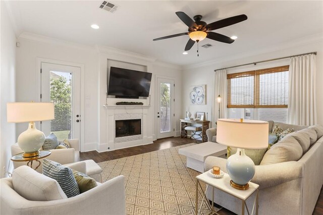 247 26th St, New Orleans, LA 70124 - living room with plenty of natural light, a fireplace, ornamental molding, ceiling fan, and wood finished floors