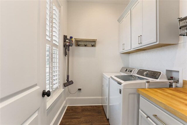 247 26th St, New Orleans, LA 70124 - washroom with cabinet space, separate washer and dryer, dark wood-style flooring, and baseboards