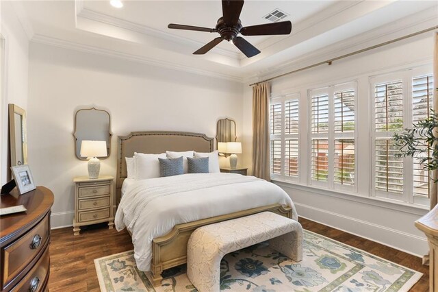 247 26th St, New Orleans, LA 70124 - bedroom featuring a raised ceiling, crown molding, dark wood-type flooring, baseboards, and ceiling fan