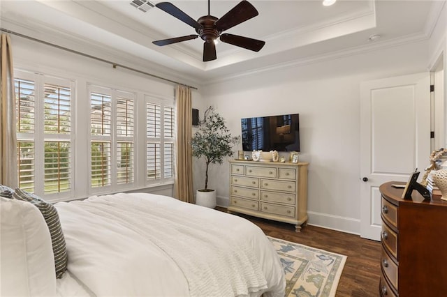 247 26th St, New Orleans, LA 70124 - bedroom with a tray ceiling, dark wood-style floors, baseboards, ornamental molding, and a ceiling fan