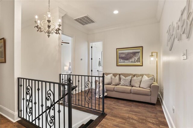 247 26th St, New Orleans, LA 70124 - hallway featuring an upstairs landing, a chandelier, ornamental molding, dark wood-style floors, and baseboards