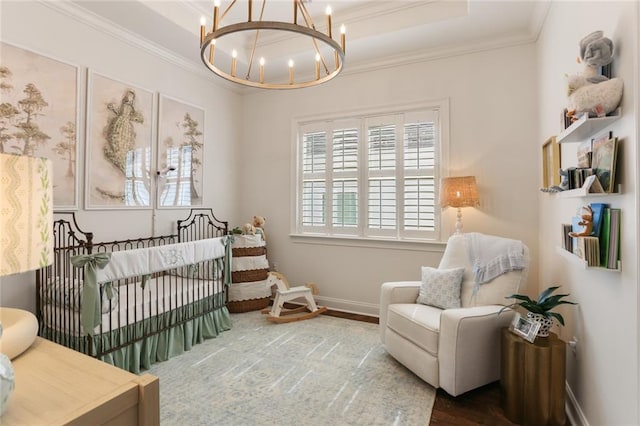247 26th St, New Orleans, LA 70124 - bedroom with a chandelier, a nursery area, ornamental molding, wood finished floors, and baseboards