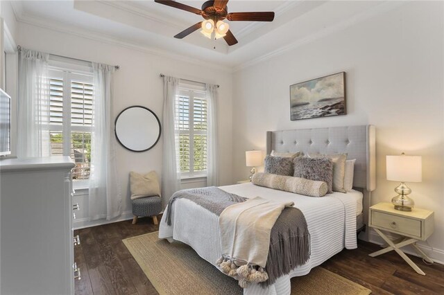 247 26th St, New Orleans, LA 70124 - bedroom with a tray ceiling, crown molding, dark wood-style floors, and a ceiling fan