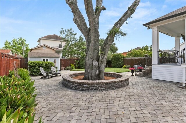 247 26th St, New Orleans, LA 70124 - fenced backyard featuring a patio area and an outbuilding