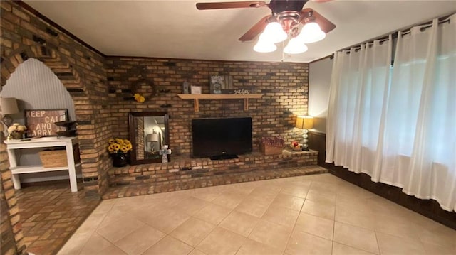 10311 Gatlin Rd, Hammond, LA 70403 - tiled living area with ceiling fan, a brick fireplace, and brick wall