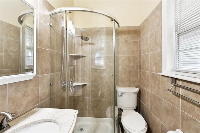 1509 N Derbigny St, New Orleans, LA 70116 - bathroom with tile walls, a shower stall, toilet, and vanity