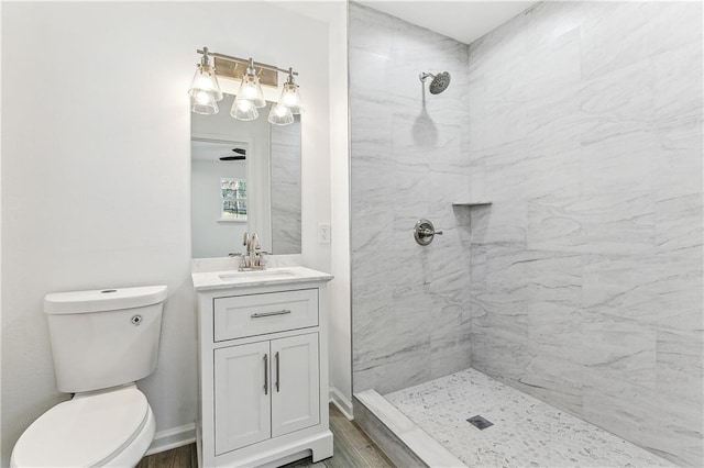 7504 Birch St, Violet, LA 70092 - full bathroom with tiled shower, vanity, toilet, wood finished floors, and baseboards