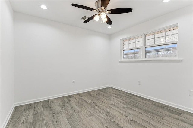 7504 Birch St, Violet, LA 70092 - empty room with ceiling fan, wood finished floors, baseboards, and recessed lighting