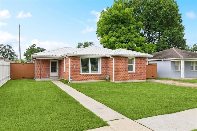 67 Cochrane Dr, Chalmette, LA 70043 - view of front of house with metal roof and brick siding