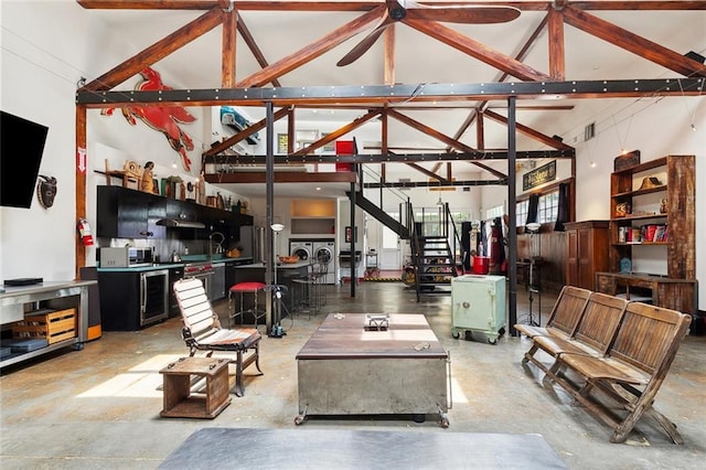 3300 Dumaine St, New Orleans, LA 70119 - living room featuring washing machine and dryer, high vaulted ceiling, concrete flooring, and ceiling fan