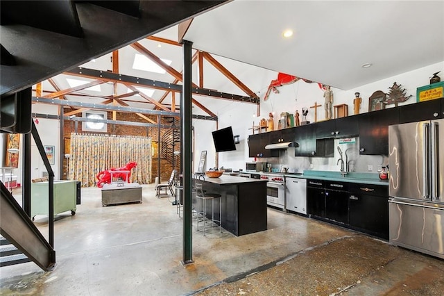 3300 Dumaine St, New Orleans, LA 70119 - kitchen featuring premium appliances, dark cabinetry, a kitchen breakfast bar, and concrete flooring