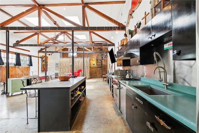 3300 Dumaine St, New Orleans, LA 70119 - kitchen with a sink, concrete floors, dark cabinets, a breakfast bar area, and a kitchen island
