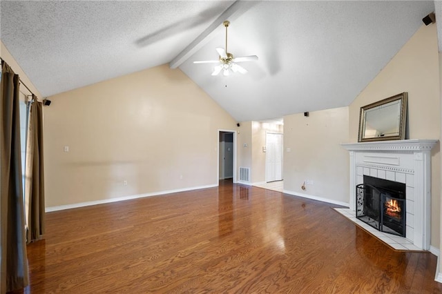 374 E Suncrest Loop, Slidell, LA 70458 - unfurnished living room with a tiled fireplace, a ceiling fan, beamed ceiling, wood finished floors, and baseboards