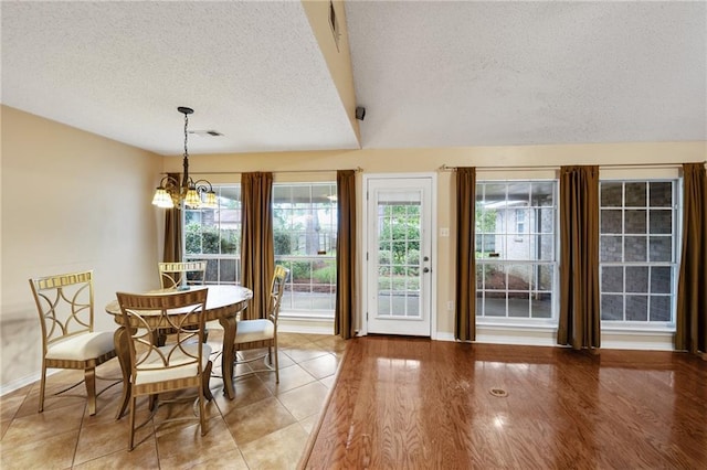 374 E Suncrest Loop, Slidell, LA 70458 - dining space with a textured ceiling, a chandelier, baseboards, healthy amount of natural light, and lofted ceiling