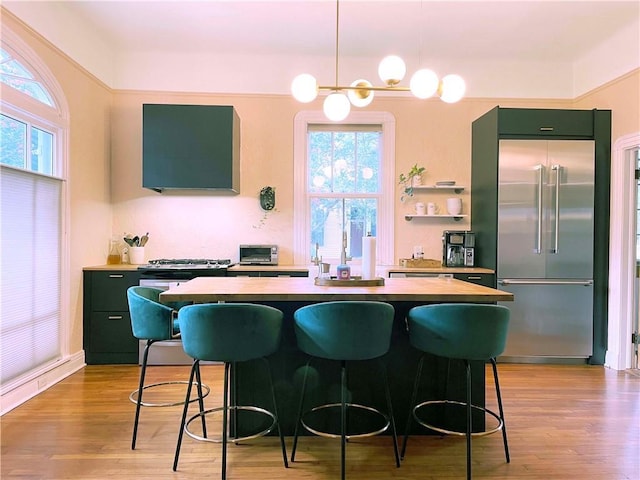 1500 Camp St, New Orleans, LA 70130 - kitchen featuring built in refrigerator, ventilation hood, a center island, light wood-type flooring, and green cabinetry