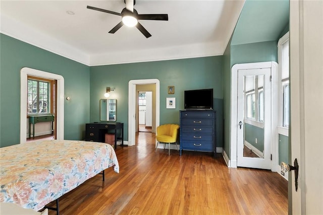 1500 Camp St, New Orleans, LA 70130 - bedroom featuring multiple windows, wood finished floors, baseboards, and arched walkways