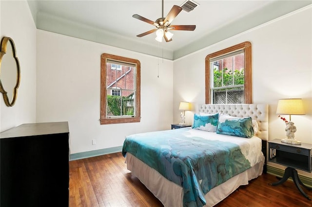 1500 Camp St, New Orleans, LA 70130 - bedroom with wood-type flooring, multiple windows, baseboards, and a ceiling fan