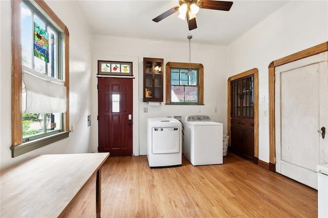1500 Camp St, New Orleans, LA 70130 - laundry room featuring washing machine and clothes dryer, a ceiling fan, and light wood-type flooring