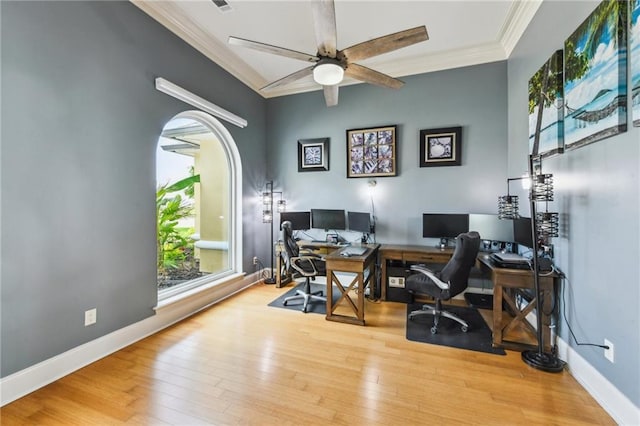 2097 S Lakeshore Blvd, Slidell, LA 70461 - office area featuring crown molding, wood finished floors, a ceiling fan, baseboards, and arched walkways