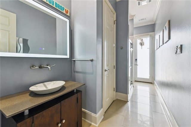 2097 S Lakeshore Blvd, Slidell, LA 70461 - bathroom with baseboards, crown molding, vanity, and tile patterned floors