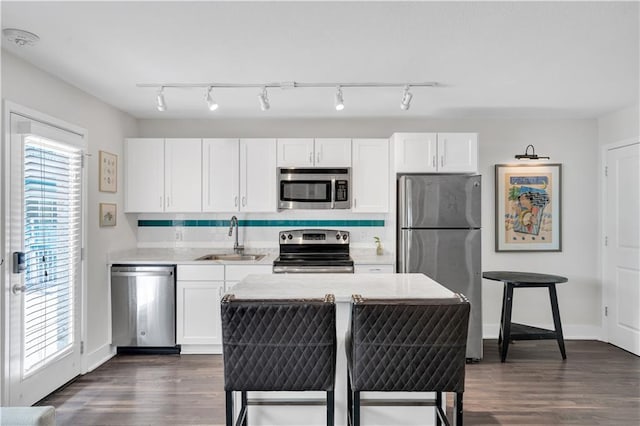 2833 St Charles Ave Unit 16, New Orleans, LA 70115 - kitchen with appliances with stainless steel finishes, a sink, light countertops, white cabinetry, and dark wood-style floors