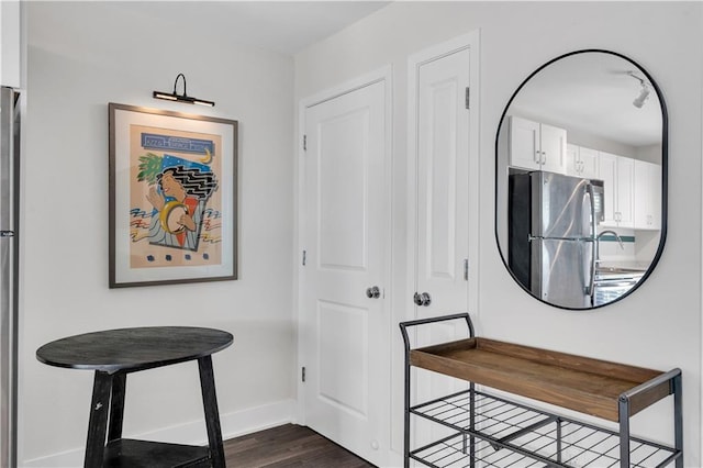 2833 St Charles Ave Unit 16, New Orleans, LA 70115 - foyer with baseboards and dark wood-style floors