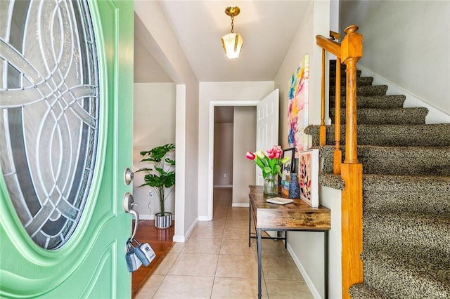 6301 Schouest St, Metairie, LA 70003 - foyer entrance featuring stairway, light tile patterned floors, and baseboards