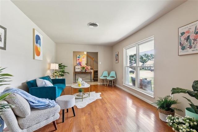 6301 Schouest St, Metairie, LA 70003 - sitting room with wood finished floors, stairs, and baseboards