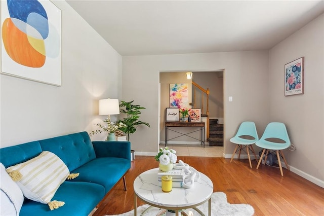 6301 Schouest St, Metairie, LA 70003 - living room featuring stairs, wood finished floors, and baseboards