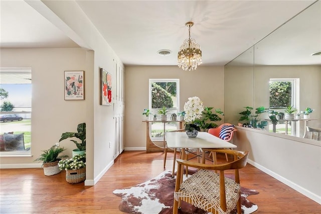6301 Schouest St, Metairie, LA 70003 - dining room with healthy amount of natural light, a chandelier, and light wood finished floors