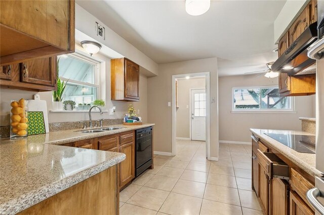 6301 Schouest St, Metairie, LA 70003 - kitchen featuring black appliances, a sink, brown cabinetry, baseboards, and light stone countertops