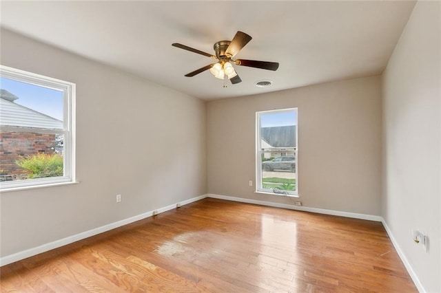 6301 Schouest St, Metairie, LA 70003 - spare room featuring healthy amount of natural light, light wood-style flooring, baseboards, and a ceiling fan