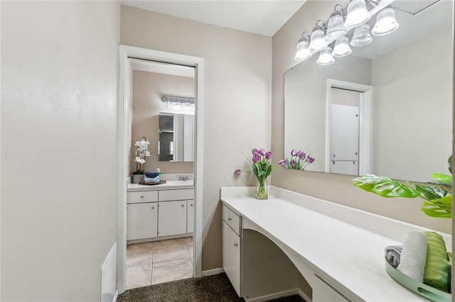 6301 Schouest St, Metairie, LA 70003 - bathroom with marble look tile flooring, vanity, and a chandelier