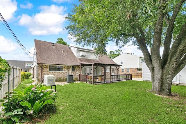 6301 Schouest St, Metairie, LA 70003 - rear view of property with central air condition unit, stone siding, and roof with shingles