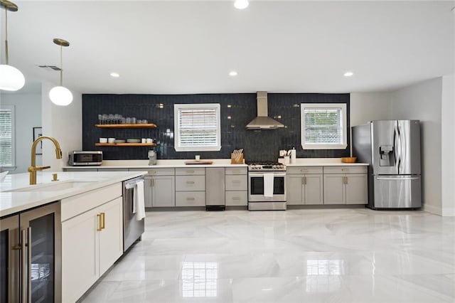 5537 Cherlyn Dr, New Orleans, LA 70124 - kitchen featuring appliances with stainless steel finishes, wine cooler, wall chimney range hood, a sink, and light marble finish floors