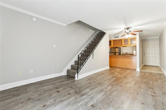 3805 Houma Blvd Unit A234, Metairie, LA 70006 - unfurnished living room featuring ceiling fan, stairs, wood finished floors, ornamental molding, and baseboards