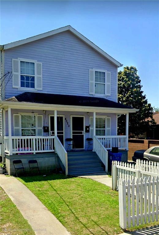4020 N Claiborne Ave, New Orleans, LA 70117 - view of front of property featuring covered porch and a front yard