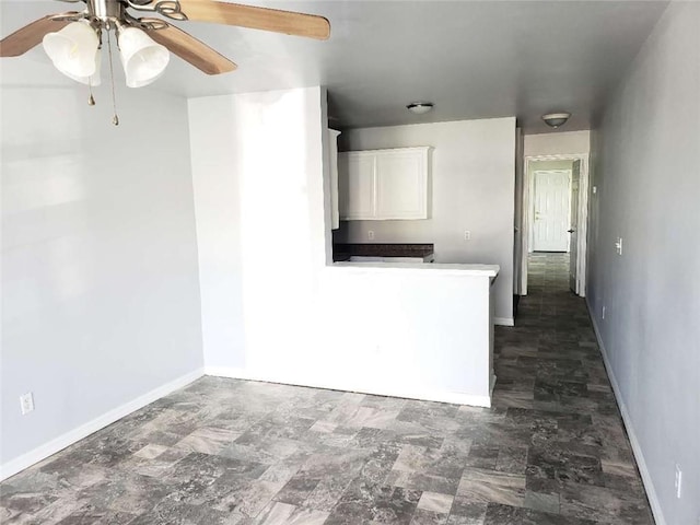 4020 N Claiborne Ave, New Orleans, LA 70117 - unfurnished living room featuring a ceiling fan and baseboards