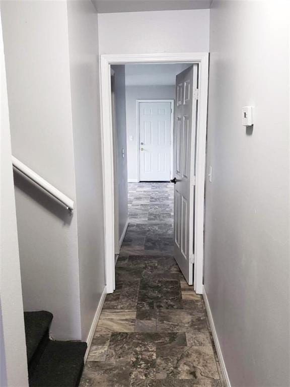 4020 N Claiborne Ave, New Orleans, LA 70117 - corridor with baseboards and dark stone finish flooring