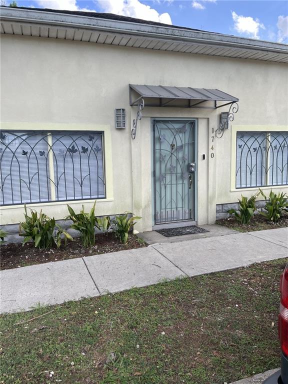 1740 Abundance St, New Orleans, LA 70119 - view of exterior entry featuring stucco siding